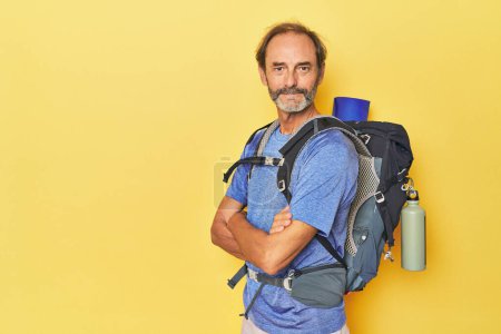 Photo for Adventurous man with mountain backpack in studio - Royalty Free Image