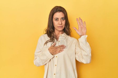 Photo for Portrait of beautiful adult woman taking an oath, putting hand on chest. - Royalty Free Image