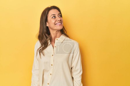 Photo for Portrait of adult woman looks aside smiling, cheerful and pleasant. - Royalty Free Image