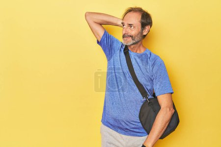 Photo for Athlete ready for the gym in studio touching back of head, thinking and making a choice. - Royalty Free Image