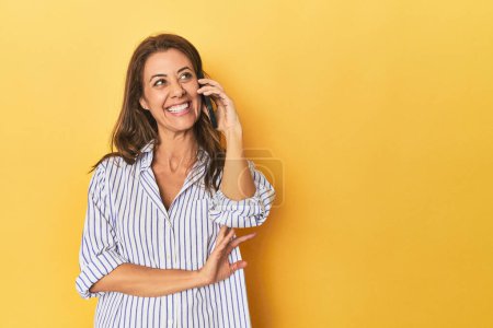 Photo for Portrait of beautiful adult woman on yellow background - Royalty Free Image