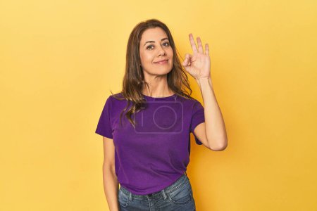 Photo for Portrait of beautiful adult woman cheerful and confident showing ok gesture. - Royalty Free Image