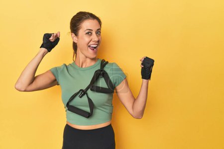 Photo for Portrait of adult woman raising fist after a victory, winner concept. - Royalty Free Image