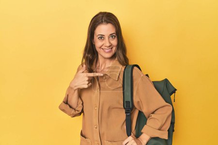 Photo for Portrait of adult woman person pointing by hand to a shirt copy space, proud and confident - Royalty Free Image