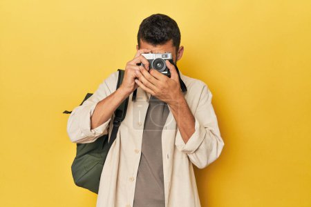 Photo for Young Hispanic traveler with vintage camera - Royalty Free Image