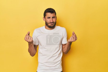 Photo for Young Hispanic man on yellow background showing that she has no money. - Royalty Free Image
