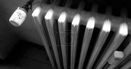 Photo for Thermostatic valve on the cast iron radiator of your home or office - Royalty Free Image