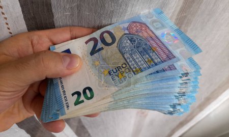 Billetes de 20 euros en manos de un hombre - riqueza