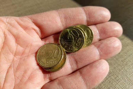 20 cent coins in a man's hand