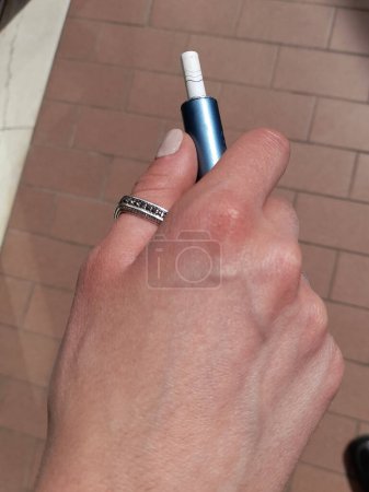 Electronic cigarette in the hands of a woman