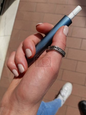 Electronic cigarette in the hands of a woman
