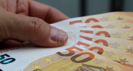 50 euro banknotes in the hands of a man - wealth