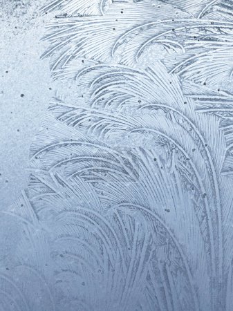 Winter frost patterns on glass. Ice crystals or cold winter background. High quality photo