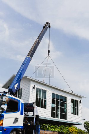 Photo for Crane lifting a knock down private house - Royalty Free Image