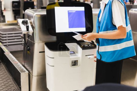 Female staff at Airport International Terminal self-service check-in area