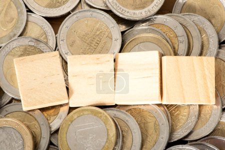 Photo for Empty wooden blocks on pile of euro coins - Royalty Free Image