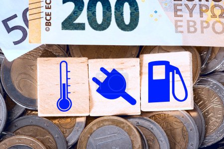 Foto de Señales de energía con efectivo en euros y monedas de fondo - Imagen libre de derechos