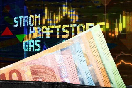 Photo for Financial chart and graphs with euro banknotes and electricity, fuel, gas inscription in german - Royalty Free Image