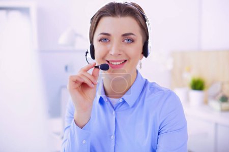 Photo for Serious pretty young woman working as support phone operator with headset in office. - Royalty Free Image