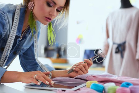 Photo for Fashion designer woman working on her designs in the studio. - Royalty Free Image