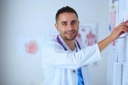 Photo for Young and confident male doctor portrait standing in medical office - Royalty Free Image