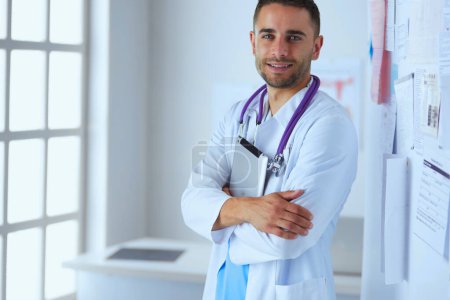 Photo for Young and confident male doctor portrait standing in medical office - Royalty Free Image
