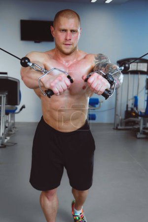 Photo for Young man training at gym with exercises . Young man. - Royalty Free Image