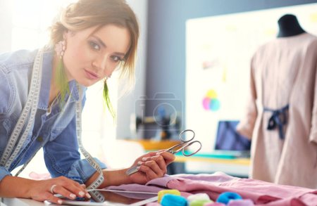 Photo for Fashion designer woman working on her designs in the studio - Royalty Free Image