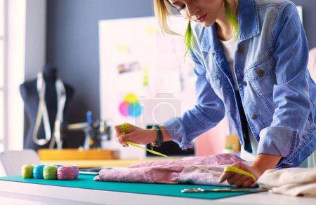 Photo for Fashion designer woman working on her designs in the studio - Royalty Free Image