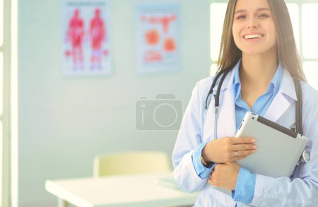 Téléchargez les photos : Médecin féminin utilisant une tablette dans le hall de l'hôpital. - en image libre de droit