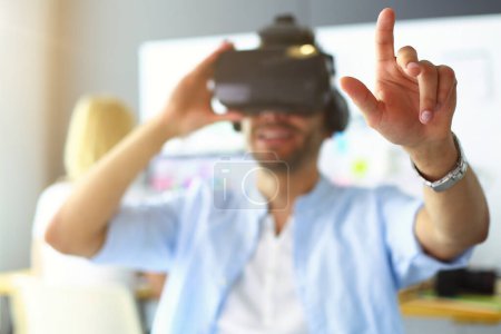 Photo for Young male software programmer testing a new app with 3d virtual reality glasses in office - Royalty Free Image
