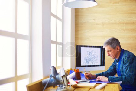 Photo for Architect working on drawing table in office. - Royalty Free Image