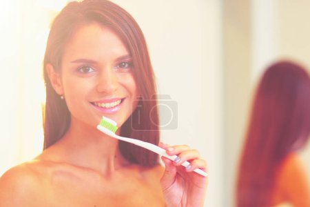 Photo for Attractive young woman applying cream on her Face. - Royalty Free Image