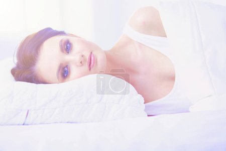 Photo for Young beautiful woman lying in bed - Royalty Free Image