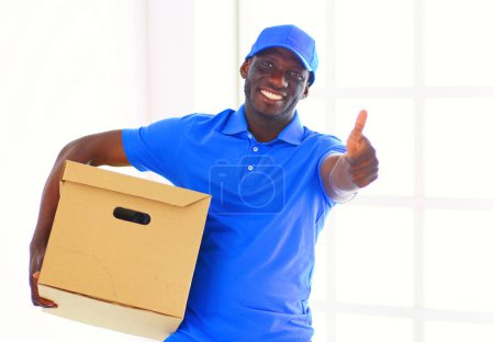 Photo for Portrait of an handsome happy deliverer with box. - Royalty Free Image