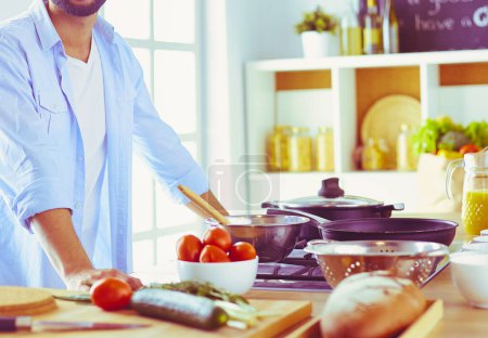 Photo for Man preparing delicious and healthy food in the home kitchen. - Royalty Free Image