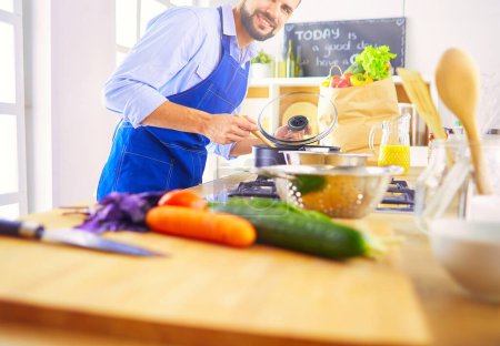 Photo for Man preparing delicious and healthy food in the home kitchen. - Royalty Free Image