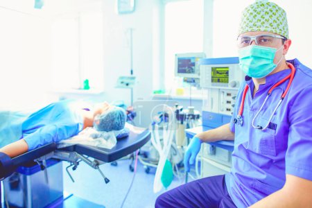 Photo for Male surgeon on background in operation room. - Royalty Free Image