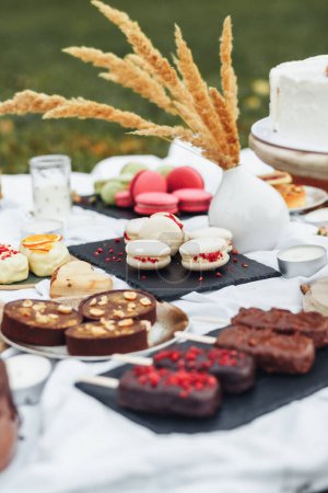 A vibrant assortment of delectable desserts displayed on a table, ranging from creamy cakes to colorful pastries and decadent chocolates.