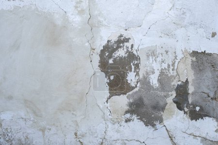 Photo for Detail of old cracked cement wall with white limewash plaster coating - Royalty Free Image