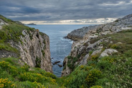 Photo for Steep cliffs in the island of Virgen del Mar, Costa Quebrada, Cantabria, Spain - Royalty Free Image
