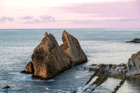 Photo for Eroded limestone sea stacks and abrasion platform in La Arnia, Costa Quebrada, Cantabria, Spain - Royalty Free Image