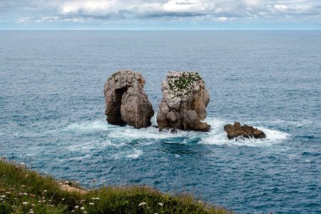 Photo for Urro del Manzano (also known as Canto del Diablo or La Puerta), rock formations carved by the wave action of the Cantabrian Sea. Urros de Liencres, Costa Quebrada, Cantabria, northern Spain - Royalty Free Image