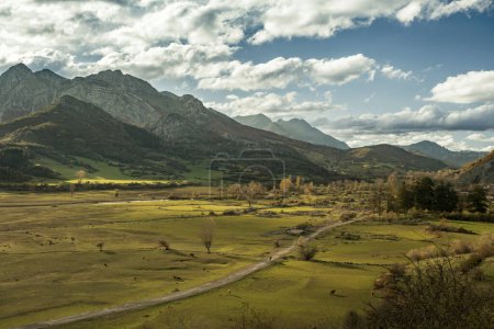 Photo for Beautiful mountain landscape with green pastures and an old road in the submerged Buron valley visible due to the low water level of the Riano reservoir, Leon, Spain - Royalty Free Image