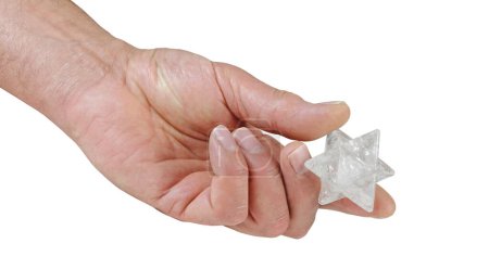 Téléchargez les photos : Holding a large clear quartz crystal merkaba - male hand offering a 2 inch merkabah against a white background - en image libre de droit