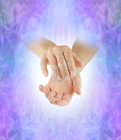 Foto de Sending distant healing concept wall art - female cupped hands emerging from lilac blue pink ethereal energy field background with copy space for message - Imagen libre de derechos