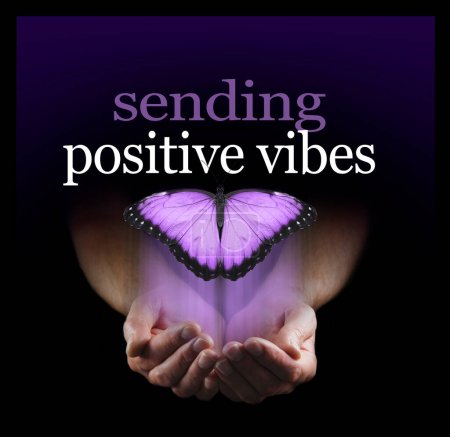 Photo for Sending you posistive vibes with a purple butterfly - male cupped hands with a big pink butterfly rising up and word saying SENDING POSITIVE VIBES emerging from a black background - Royalty Free Image