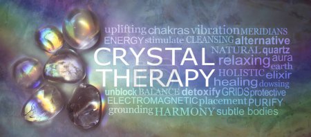 Photo for Crystal therapy word cloud on rustic rainbow background - selection of rainbow light infused tumbled healing stones against a dark multicoloured background with a relevant word cloud - Royalty Free Image