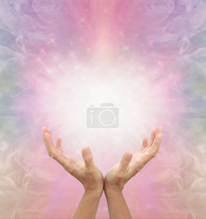 Téléchargez les photos : Connexion à l'intelligence divine Reiki Healing Vibe Energy - Mains coupées féminines avec une énergie blanche brillante sur un fond de formation d'énergie rose éthéré et un espace pour la copie - en image libre de droit
