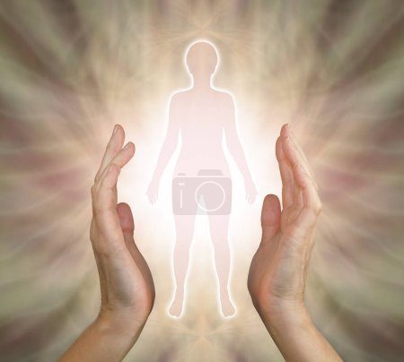Photo for Visualise the person you are sending healing vibes to and connect - female parallel hands with silhouette of woman between against an outward flowing golden energy field - Royalty Free Image